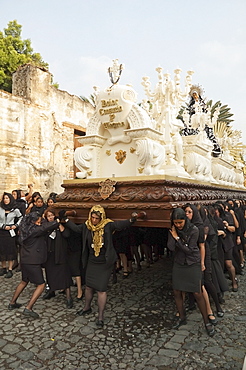 Women dressed in mourning carry the anda (float) of the sorrowful Virgin Mary during the Holy Burial Procession on Good Friday in Antigua Guatemala, Sacatepuquez, Guatemala