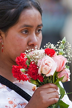 Maya woman with a bouquet of roses & carnations, Antigua, Sacatepuquez, Guatemala