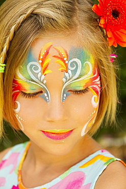 Hawaii, Young girl wearing colorful facepaint.