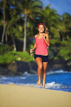 Hawaii, Oahu, Lanikai, Young woman running on beach.