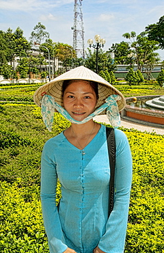 Vietnam, Saigon, Ho Chi Minh, Portrait of a young Vietnamese woman in traditional clothing.