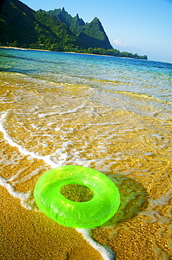 Hawaii, Kauai, Tunnels beach, Green innertube on the beach.