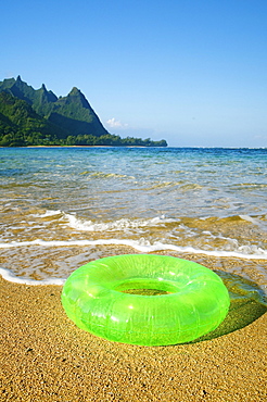 Hawaii, Kauai, Tunnels beach, Green innertube on the beach.