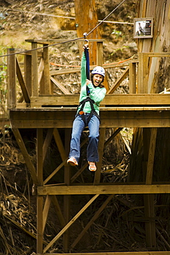 Hawaii, Maui, Zipline Adventure, Woman riding the zipline.