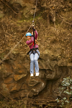 Hawaii, Maui, Zipline Adventure, Young girl on the line.