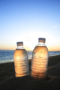 Hawaii, Oahu, Bottle of water on the beach.