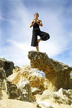 Hawaii, Kauai, Mahaulepu, Woman doing yoga.