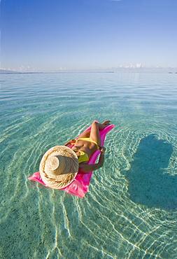 French Polynesia, Tahiti, Moorea, Woman floating in water.