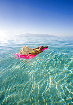 French Polynesia, Tahiti, Moorea, Woman floating in water.