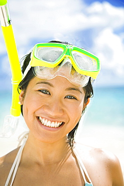 Hawaii, Oahu, Lanikai, Young Japanese woman wearing snorkle gear on the beach.