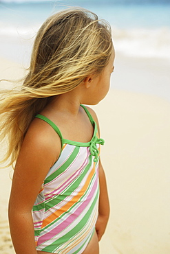 Hawaii, Oahu, little girl poses on beach.