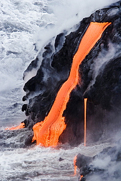 Hawaii, Big Island, near Kalapana, Pahoehoe lava flowing from Kilauea into Pacific Ocean.