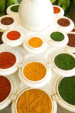 India, Agra, Abstract colorful bowls of spices in vases from above.