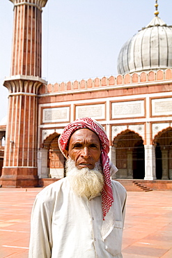 India, Delhi, Jama Masjid, a man standing within the largest mosque in the country.