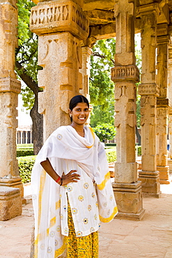 India, New Delhi, Qutub Minar Complex, Beautiful woman in colorful sari.