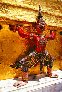 Thailand, Bangkok, Wat Phra Keo, closeup detail of Ramakien statue outdoors, colorful outfit and headdress