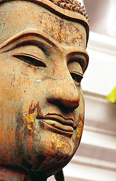 Thailand, Bangkok, Wat Ratchabophit, Closeup of face of a weathered Buddha statue