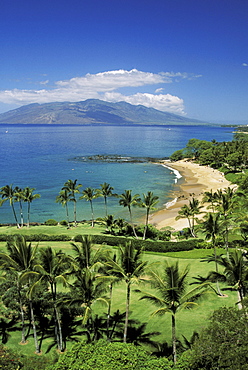 Hawaii, Maui, Wailea coastline, Ulua Beach, golf course in foreground, island in distance.