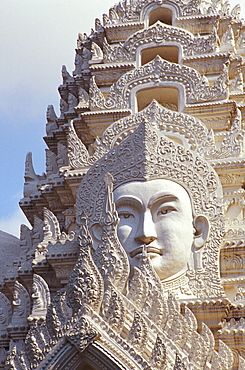 Thailand, Bangkok, Wat Ratchapradt, Buddha Image on ornate stone temple.