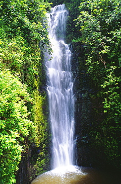 Hawaii, Maui, Hana, Wailua Falls valley, Waterfall surrounded by lush greenery