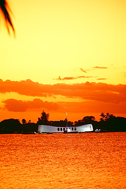 Hawaii, Oahu, Pearl Harbor, Full view of Arizona Memorial at sunset, bright orange yellow sky