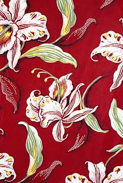 Closeup of red Aloha shirt with orchid flowers