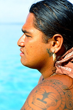 French Polynesia, Tahiti, Huahine,Tahitian man with tattoos, view from side