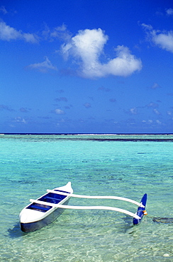 Guam, Agana Bay, white and blue outrigger canoe in calm turquoise water