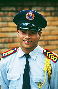 Laos, Luang Prabang, Portrait of a uniformed security guard.