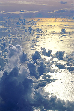 View from above clouds over ocean, sun reflections A35G