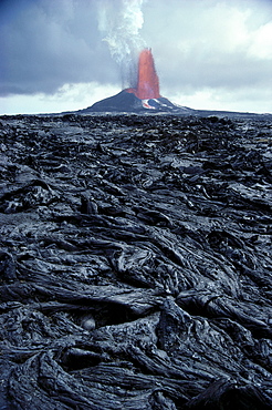 Hawaii, Big Island, Pu'u O'o eruption, pahoehoe lava in foreground, fountain background A27F