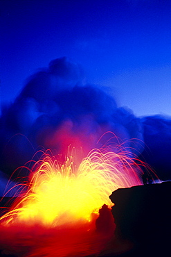 Hawaii, Big Island, Hawaii Volcanoes National Park, Lava explodes as flow hits ocean, fountain bright blue sky C1634