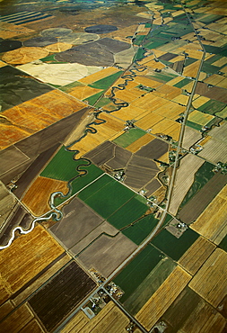 Agriculture - Aerial view of cultivated and fallow agricultural fields with a highway and river passing through / near Idaho Falls, Idaho, USA.