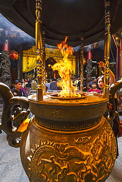 Incense and paper offerings burning in an incense burner at the Altar of Heaven (Tiantan), Tainan, Taiwan