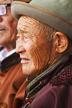 Elderly man wearing a deel, the Mongolian traditional costume, at the Naadam Festival in Mandal Ovoo, Ã–mnÃ¶govi Province, Mongolia