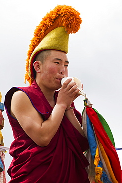 Buddhist monk blowing a conch shell by the Larviran Temple at the Erdene Zuu Monastery, Karakorum (Kharkhorin), Ã–vÃ¶rkhangai Province, Mongolia