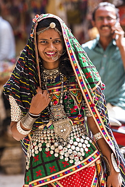 Portrait of a Hindu Indian woman in colourful traditional clothing and accessories, Jaisalmer Fort, Jaisalmer, Rajasthan, India