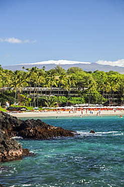 Kaunaoa Beach, Mauna Kea Beach and Hotel, and a view of Mauna Kea with snow on the Big Island, Island of Hawaii, Hawaii, United States of America