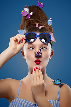 Glamour shot of girl with butterflies on a blue background, Toronto, Ontario, Canada