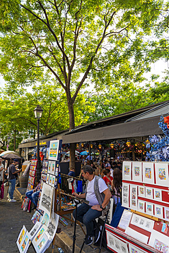 Street scene with stall selling prints, Montmartre, Paris, France, Europe