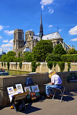 Artist by the River Seine overlooking Notre Dame, Paris, France, Europe