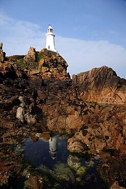 Rocks and white La Corbiere Lighthouse, Jersey, Channel Islands, United Kingdom, Europe