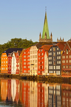 Nidaros Cathedral and old fishing warehouses reflected in the River Nidelva, Trondheim, Sor-Trondelag, Norway, Scandinavia, Europe 