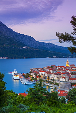 Elevated view over Korcula's picturesque Stari Grad (Old Town) illuminated at dusk, Korcula Town, Korcula, Dalmatia, Croatia, Europe