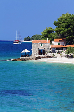 Restaurant at the beach with sailing boat, Bol, Brac Island, Dalmatia, Croatia, Europe