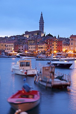 Ships and boats in the harbour and the old town with cathedral of St. Euphemia at dusk, Rovinj, Istria, Croatia, Europe