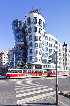 Tram in front of the Dancing House (Ginger and Fred) by Frank Gehry, Prague, Bohemia, Czech Republic, Europe