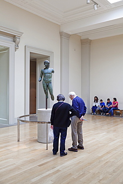 Visitors looking at a sculpture, British Museum, Bloomsbury, London, England, United Kingdom, Europe