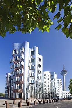 Neuer Zollhof, designed by Frank Gehry, and Rheinturm tower, Media Harbour (Medienhafen), Dusseldorf, North Rhine Westphalia, Germany, Europe 