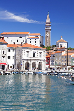 Waterfront buildings at the harbour and bell tower of Cathedral of St. George, Piran, Istria, Slovenia, Europe
